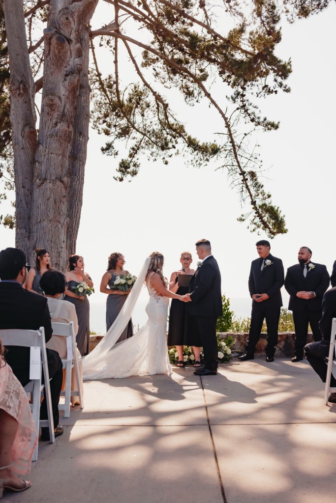 A bride and groom exchange their vows on the bluff overlooking the ocean at Seascape Beach Resort in Aptos, California. Bloom & Forage provided wedding planning and custom floral design, creating a seamless celebration that complemented the natural beauty of the coastal setting.